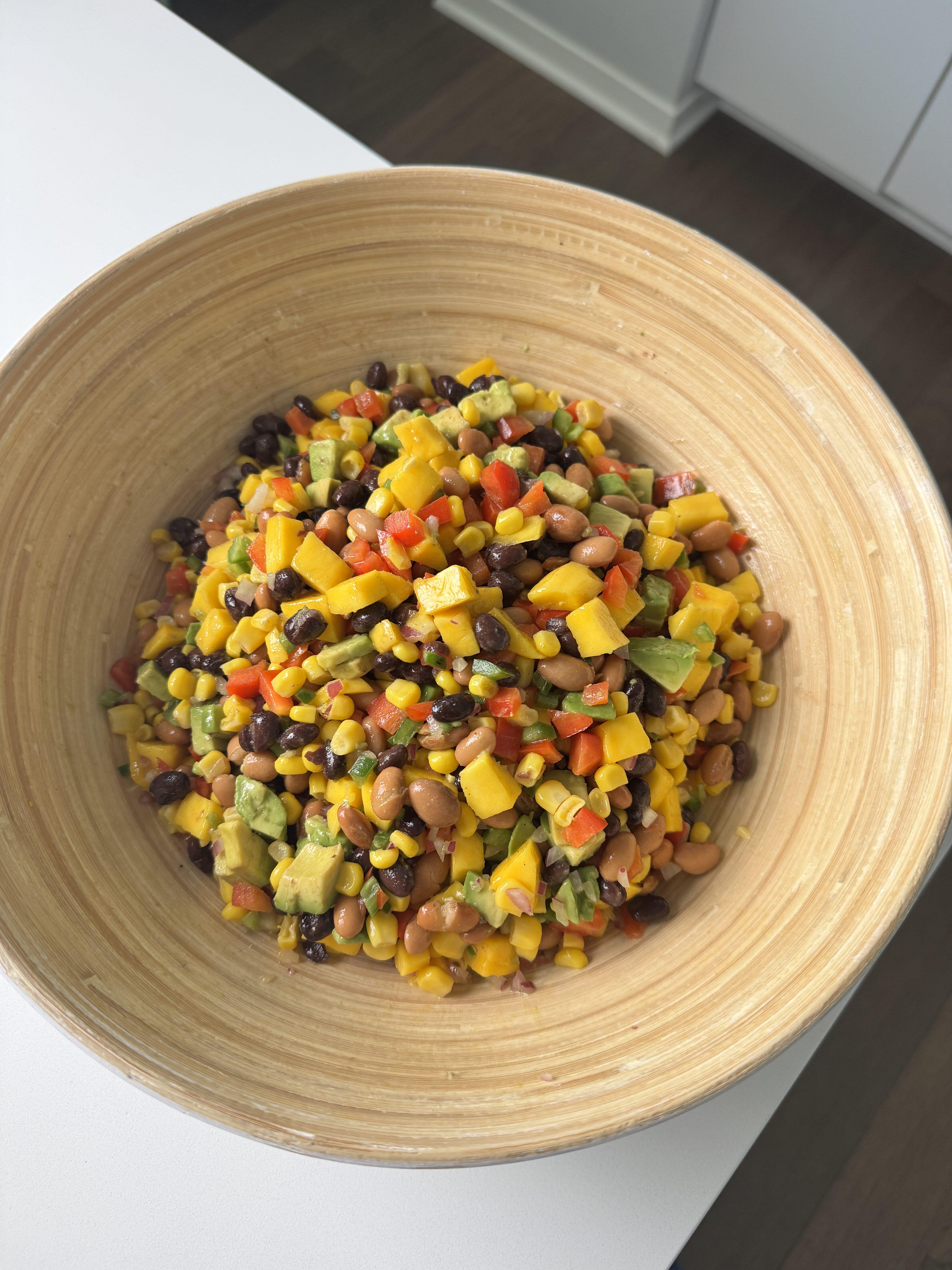 close up of mango cowboy caviar in a wooden bowl