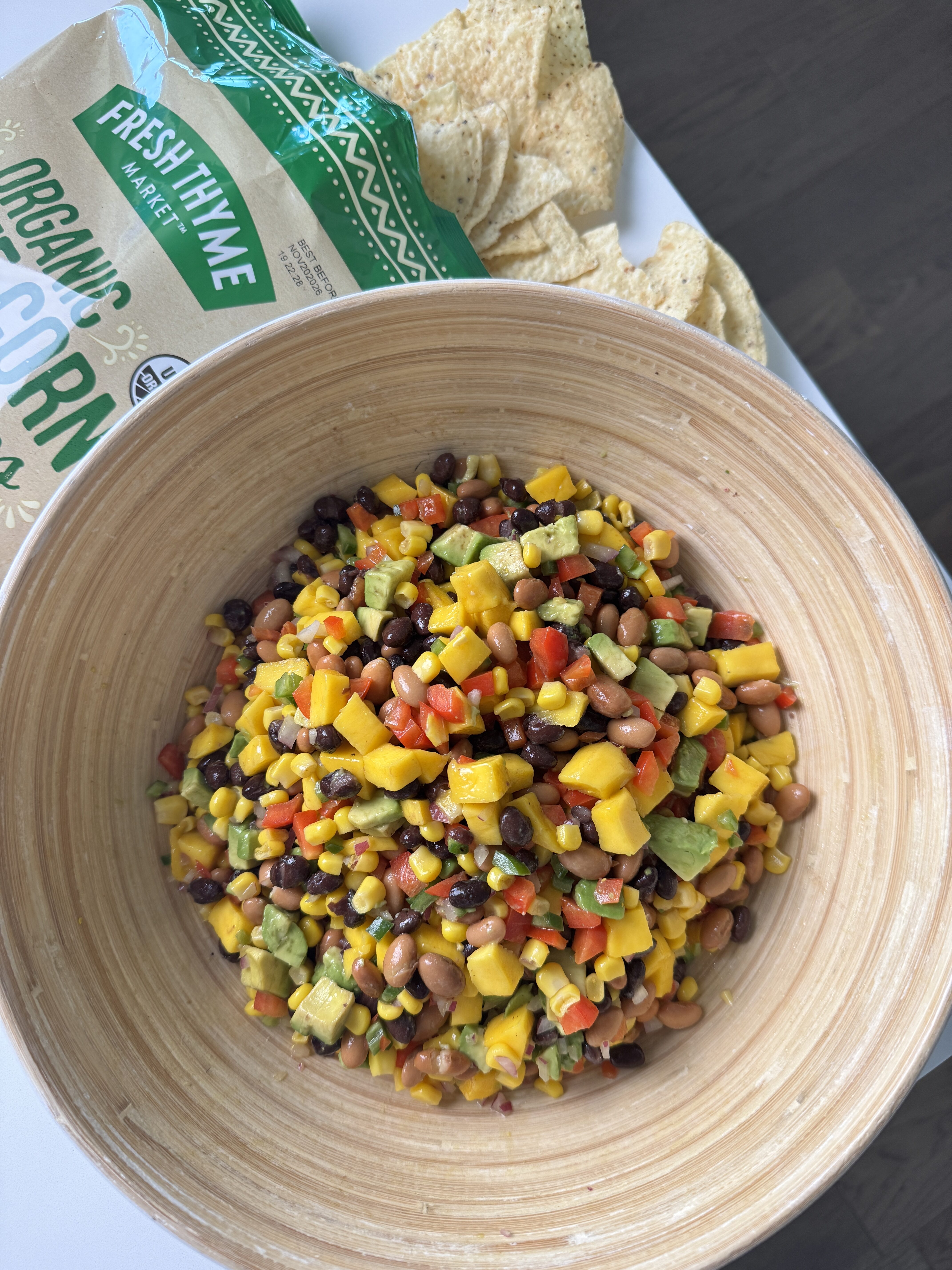 mango cowboy caviar in a bowl with tortilla chips