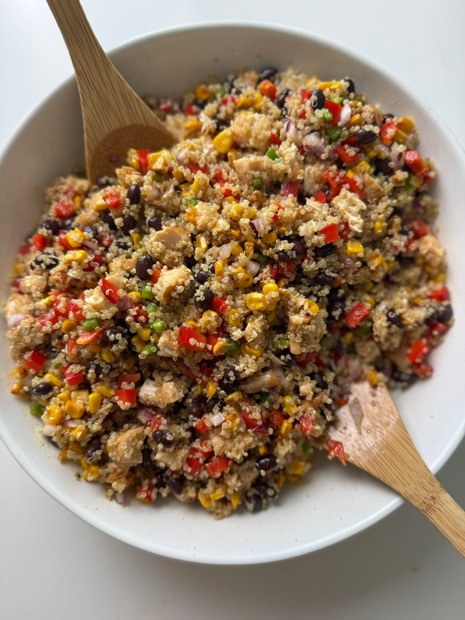 southwest chicken quinoa salad in a bowl — 30-minute meal prep with black beans, corn, jalapeño, and lime-maple dressing