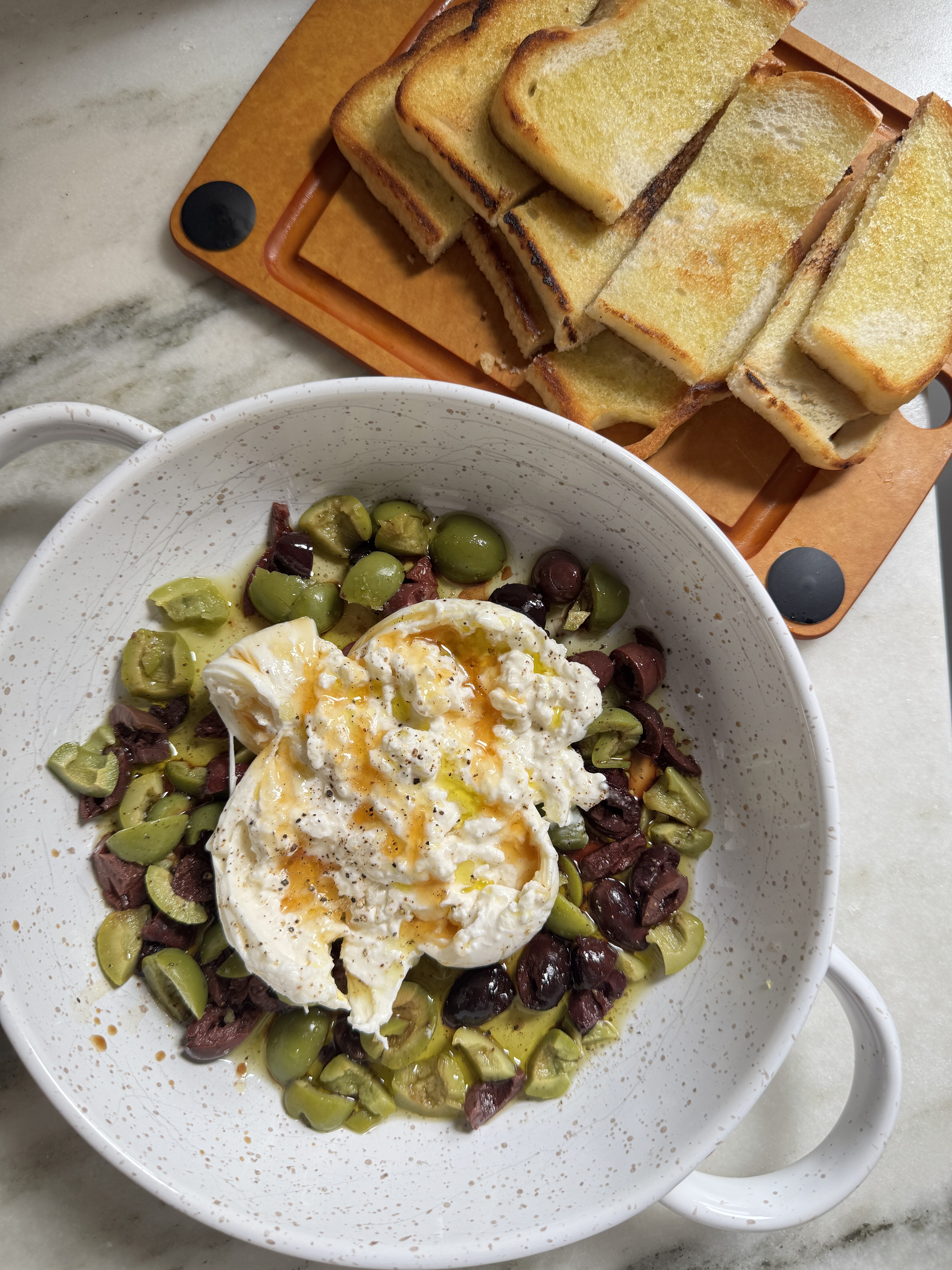 Olives and burrata with olive oil and balsamic vinegar