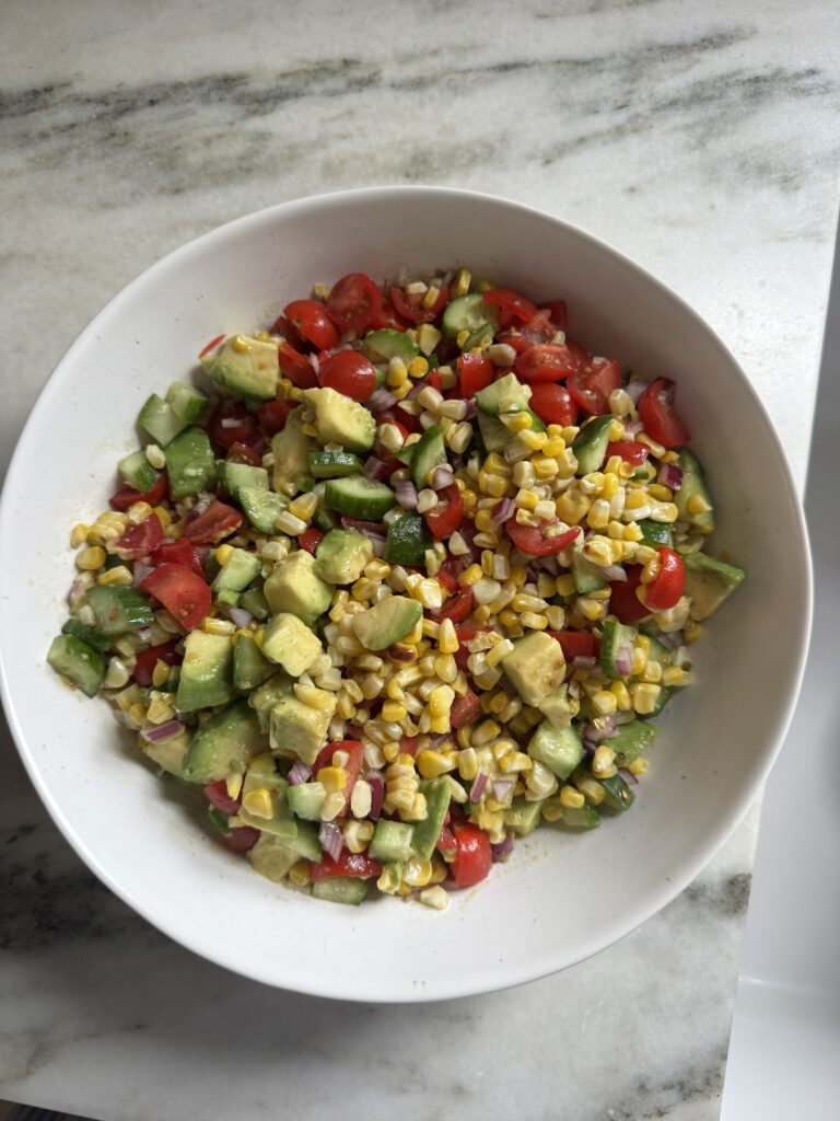 Close-up of chopped corn salad with charred corn and creamy avocado