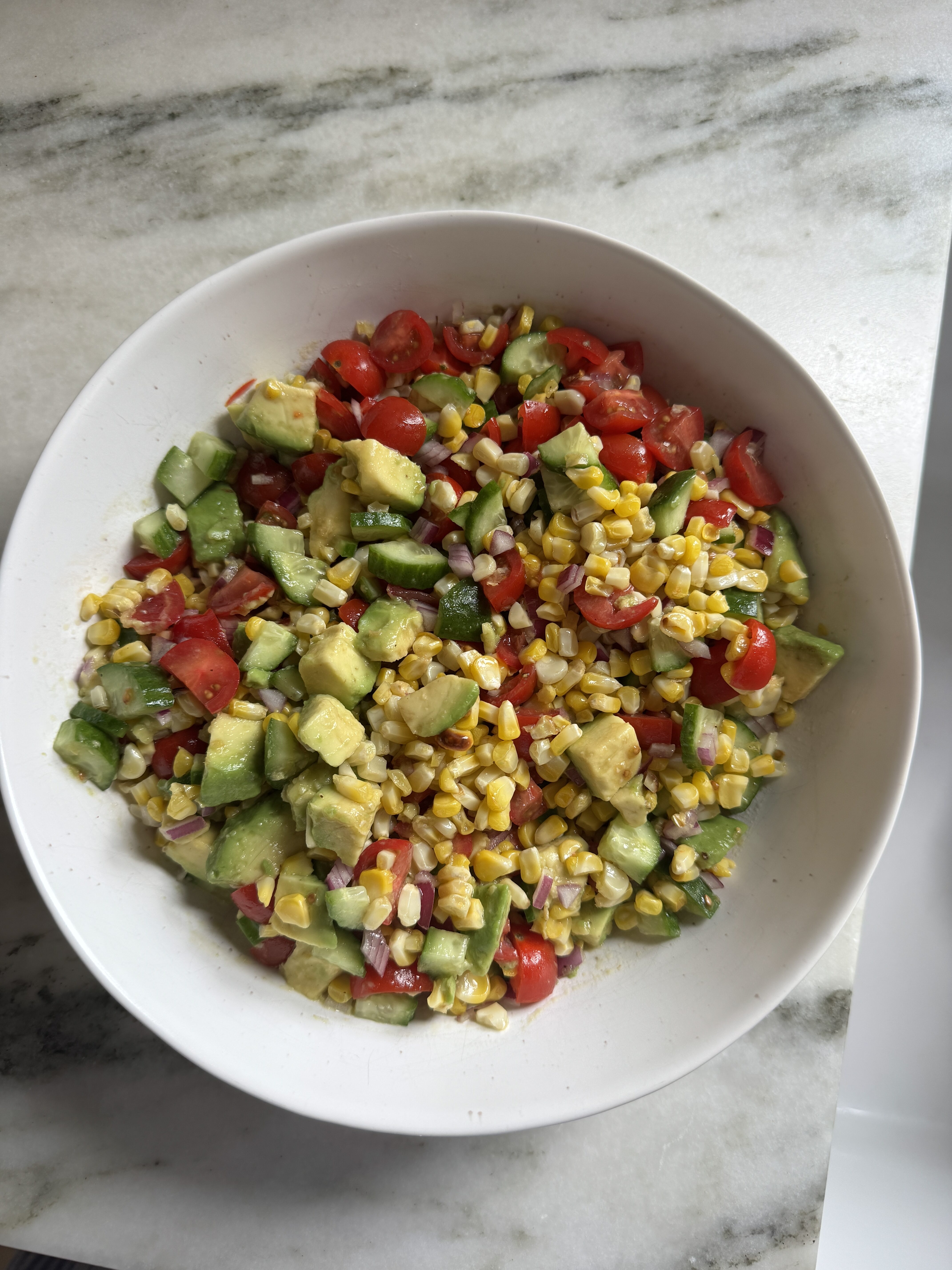 Close-up of chopped corn salad with charred corn and creamy avocado