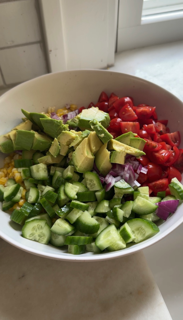 Overhead of chopped corn salad with lime maple dressing
