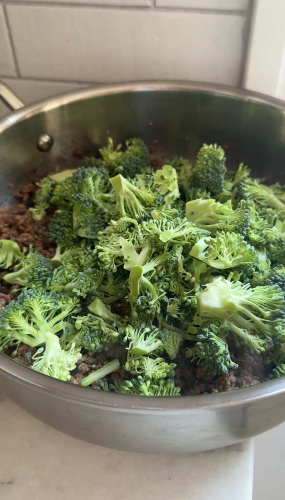 A bowl of ground beef and broccoli served over rice