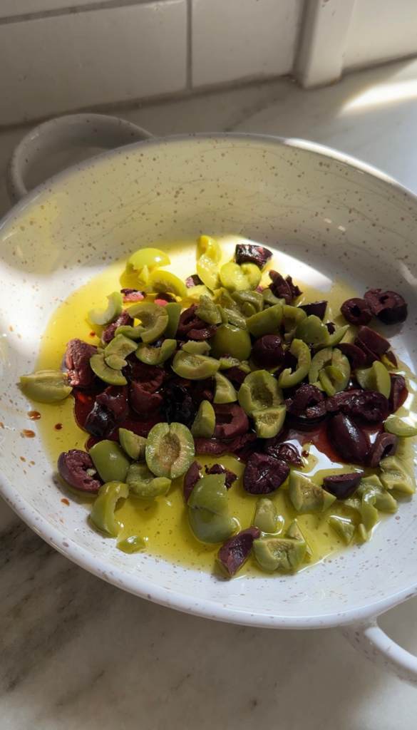 Creamy burrata topped with marinated kalamata and castelvetrano olives and a hot honey drizzle