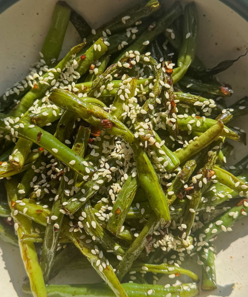 Close up of sesame green beans with toasted sesame seeds and chili flakes