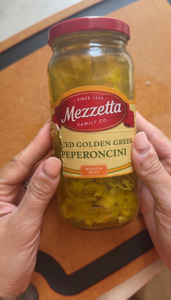 A jar of Mezzetta sliced golden Greek pepperoncini for pepperoncini chicken salad
