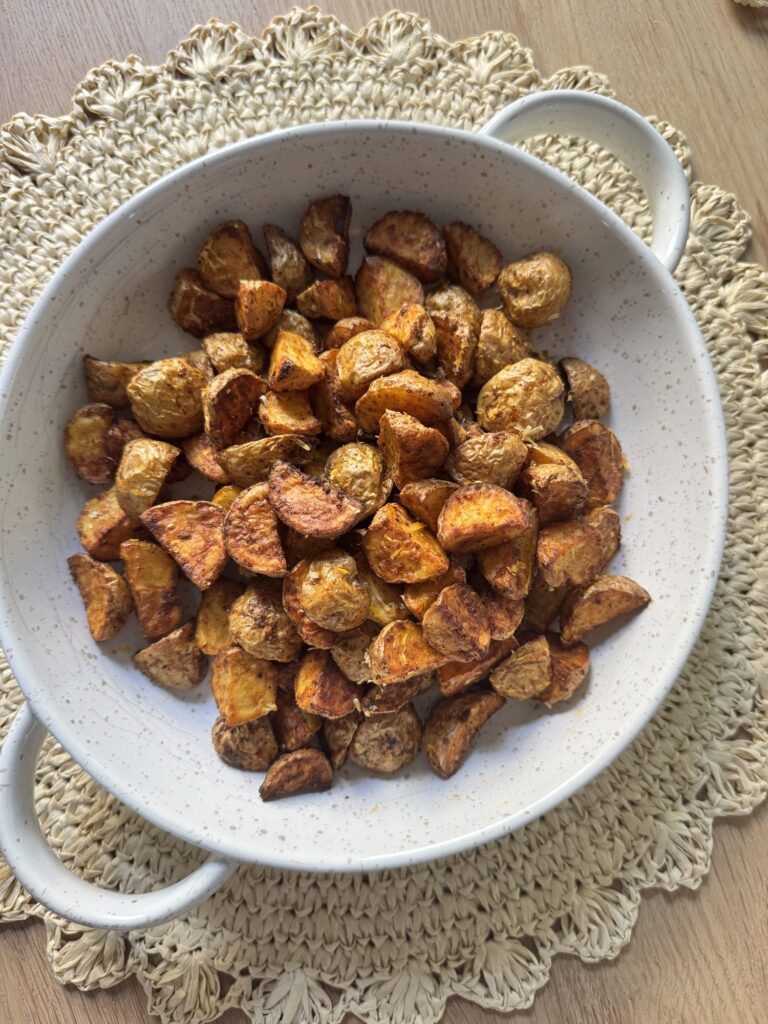 Crispy air fryer parmesan potatoes in a white serving bowl