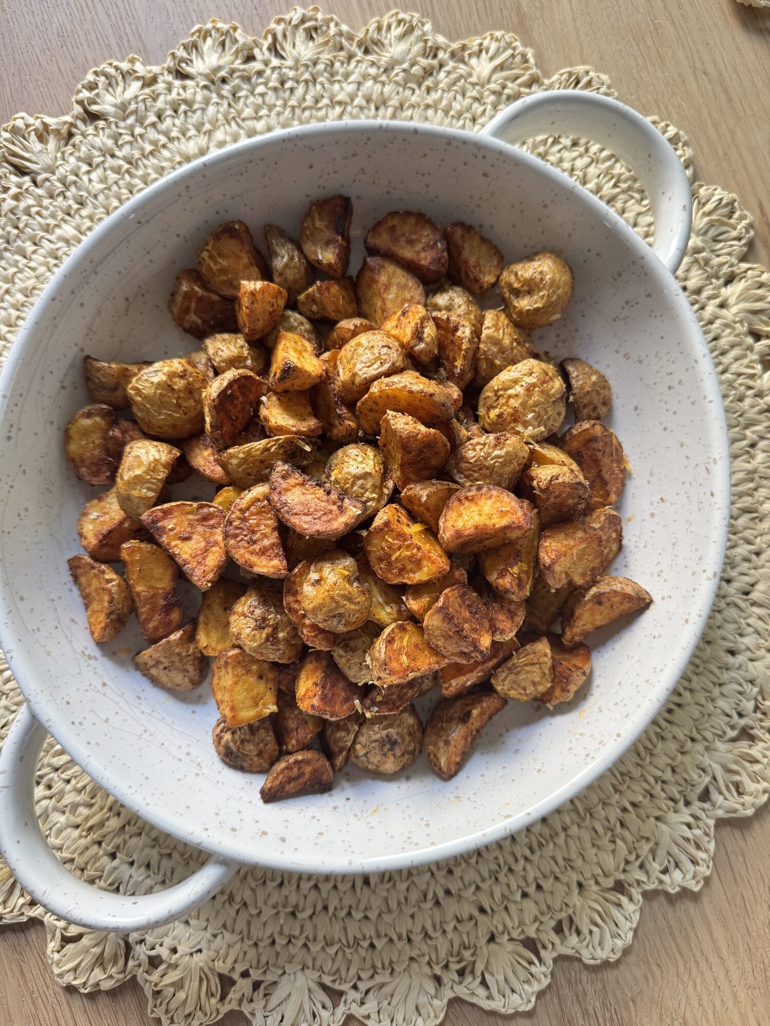 Crispy air fryer parmesan potatoes in a white serving bowl