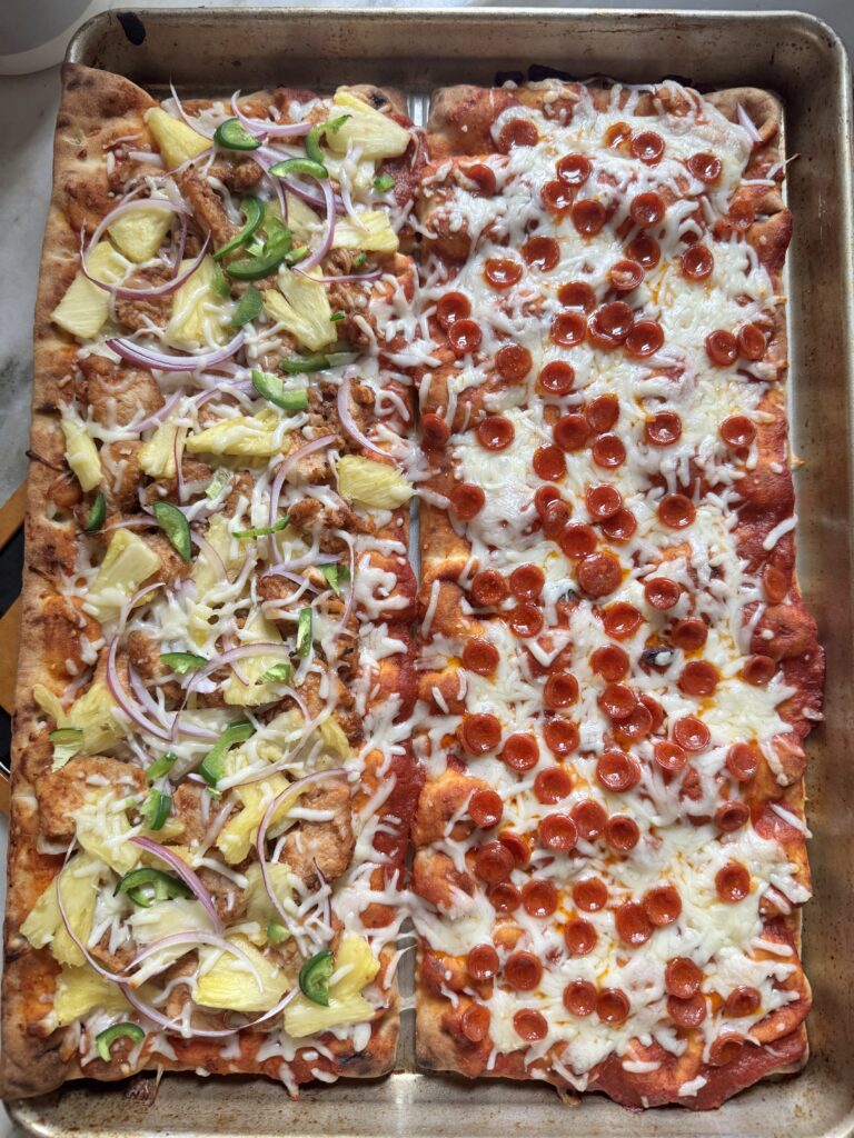 BBQ chicken and mini pepperoni flatbread pizzas assembled on a baking sheet