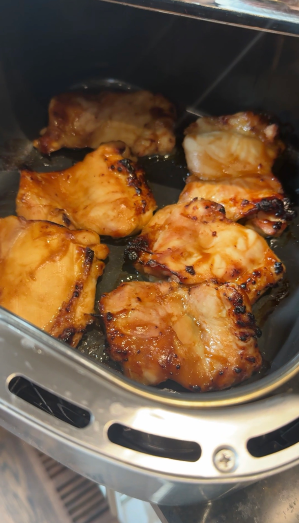 Teriyaki marinated chicken thighs in an air fryer basket