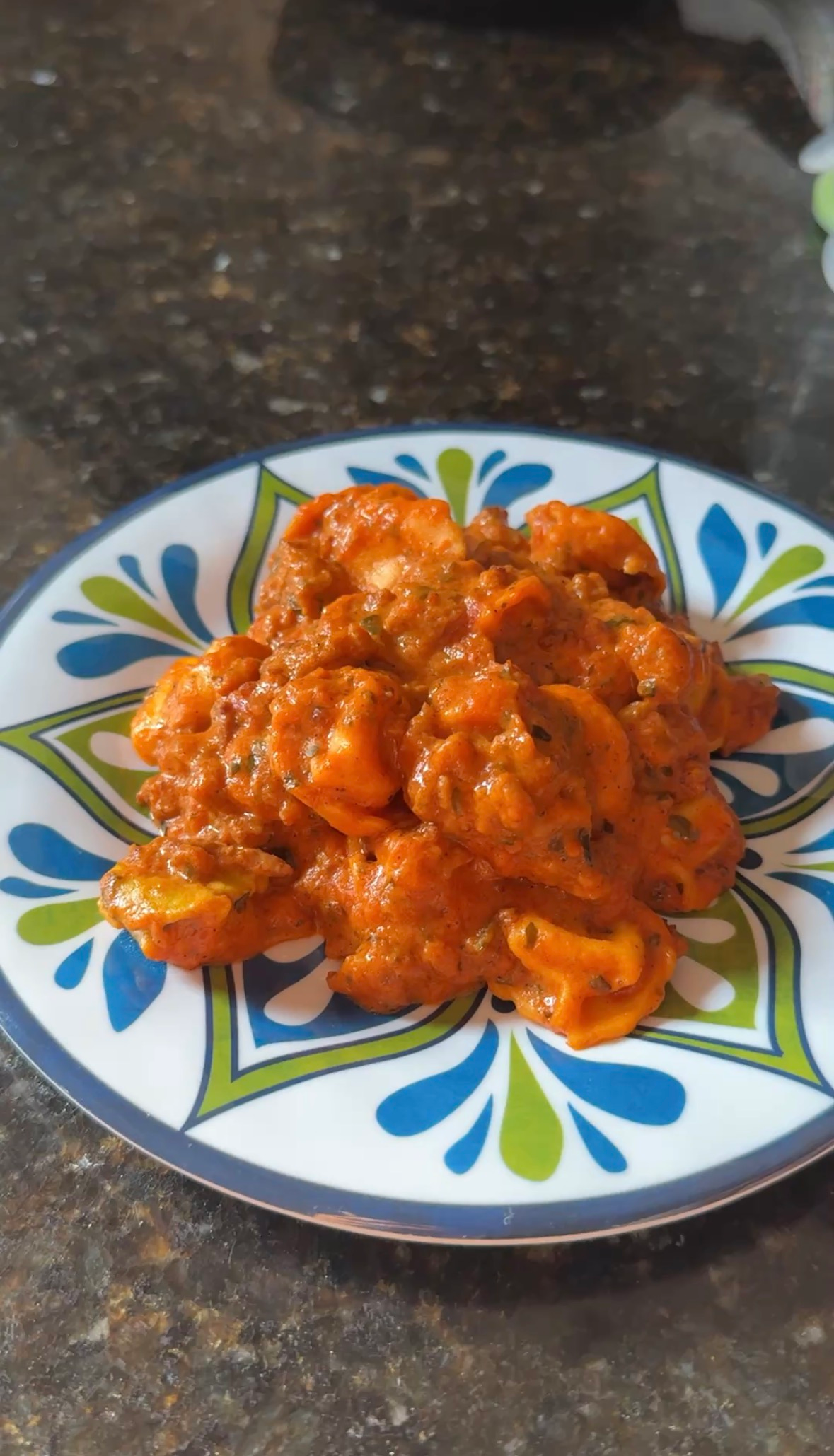 A plate of creamy sausage tortellini in a rich pink sauce