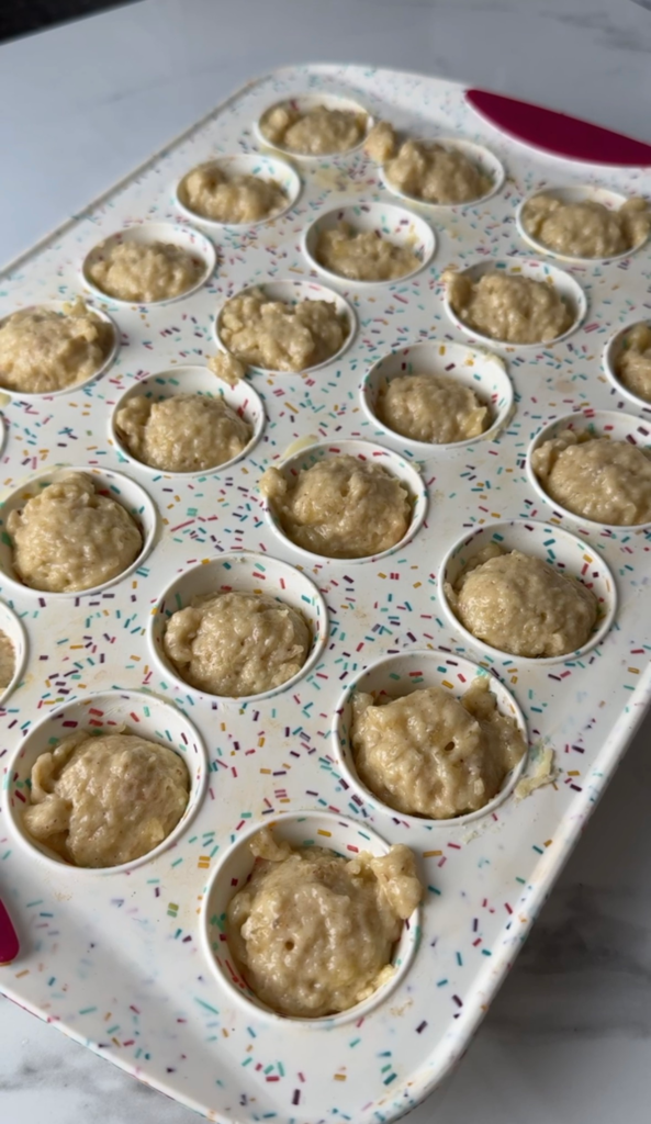 Mini muffin tin filled with batter before baking