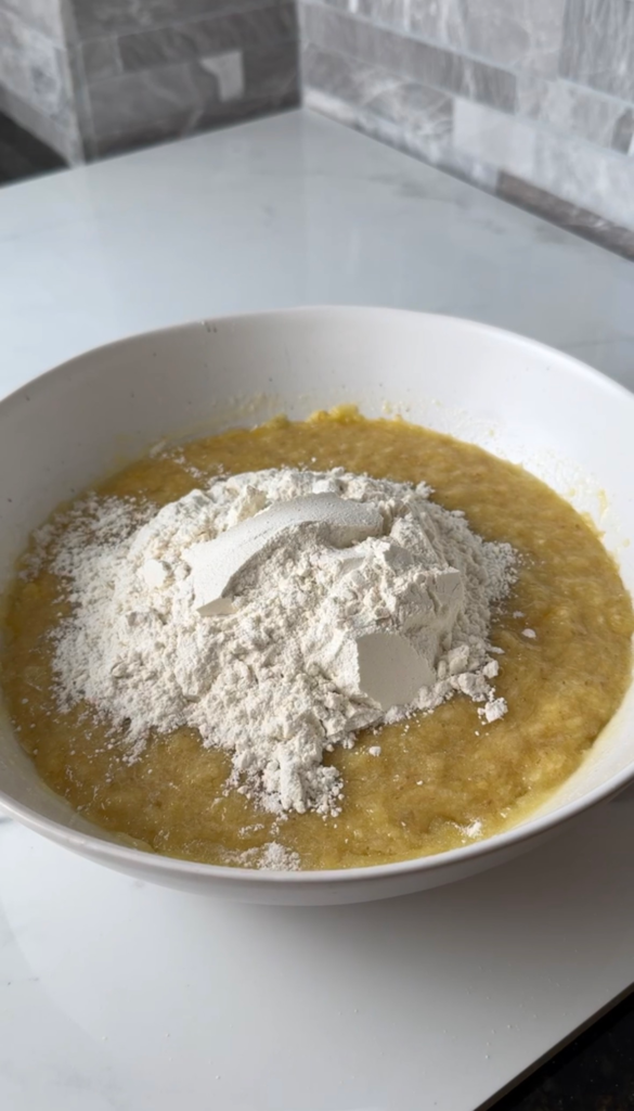 Adding flour to the muffin batter