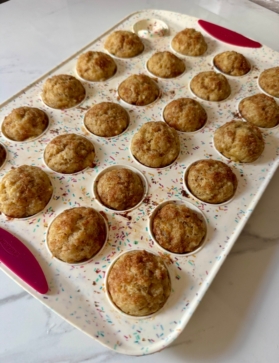 Mini apple banana muffins baked in a mini muffin tin
