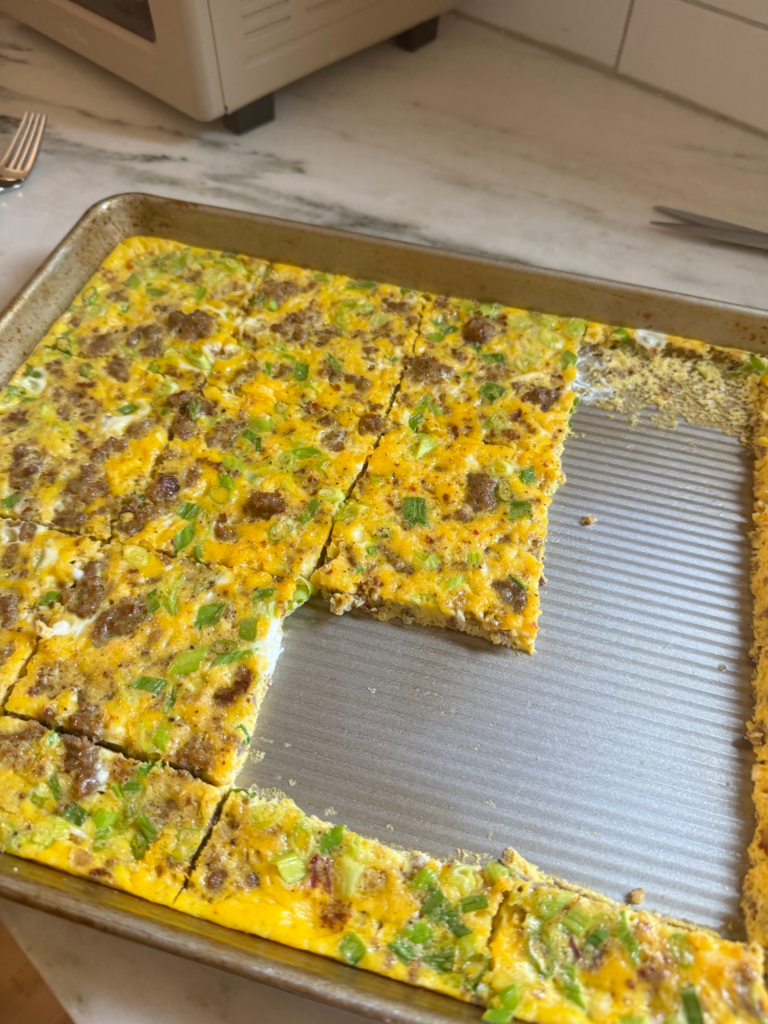 Baked sheet pan eggs cut into squares for breakfast sandwiches