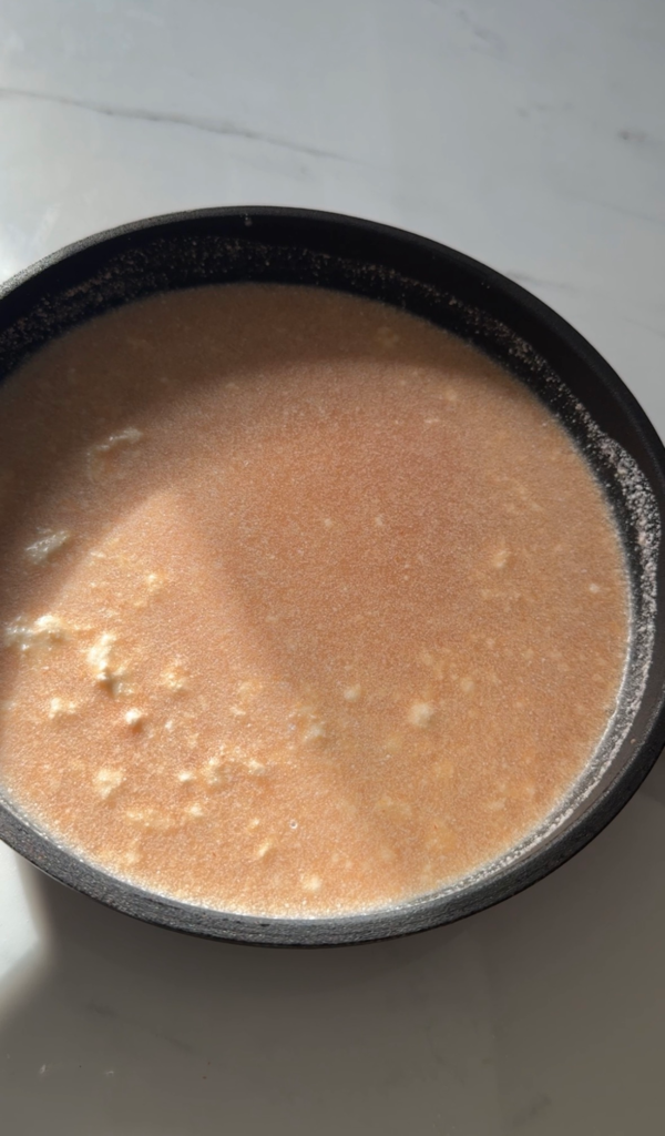 Coconut red curry broth simmering in a pot