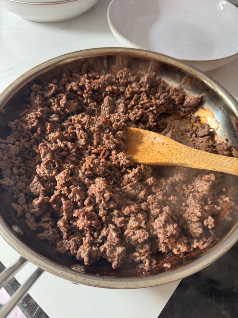 Ground beef browning in a skillet