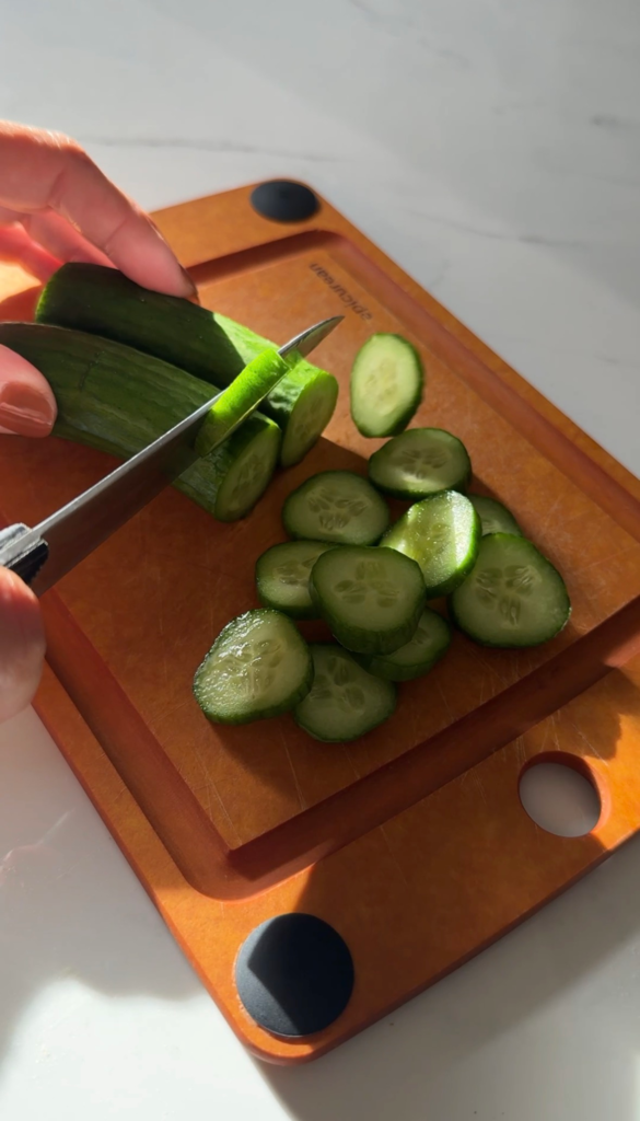 Slicing Persian cucumbers on a cutting board