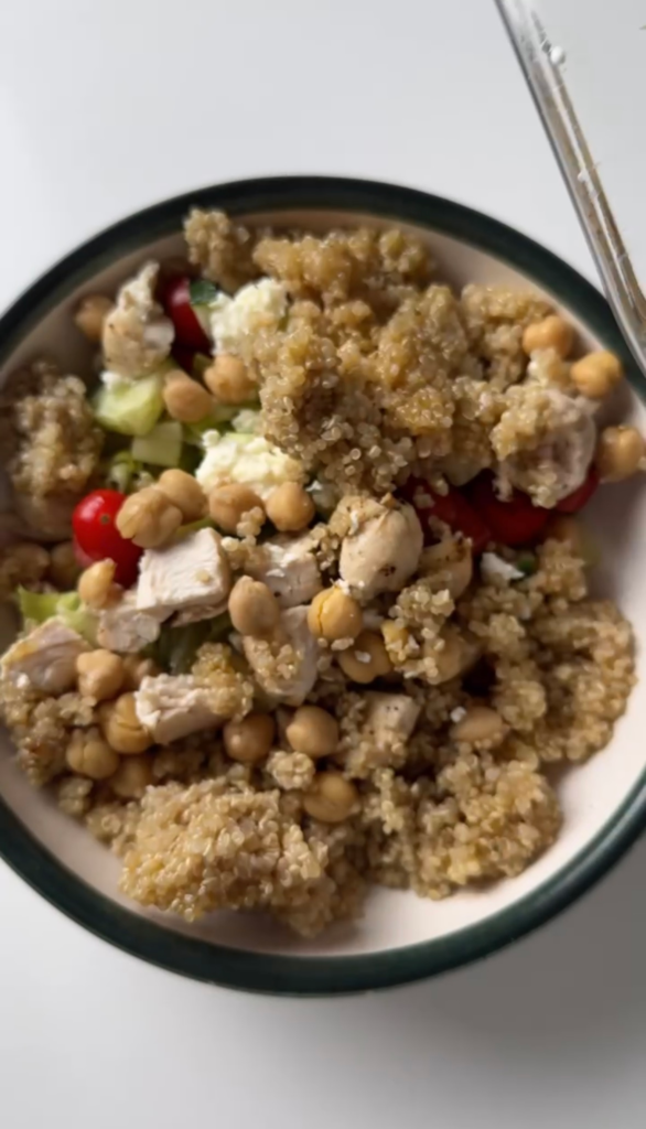 A bowl of chickpea chicken salad with quinoa, chicken, chickpeas, and feta
