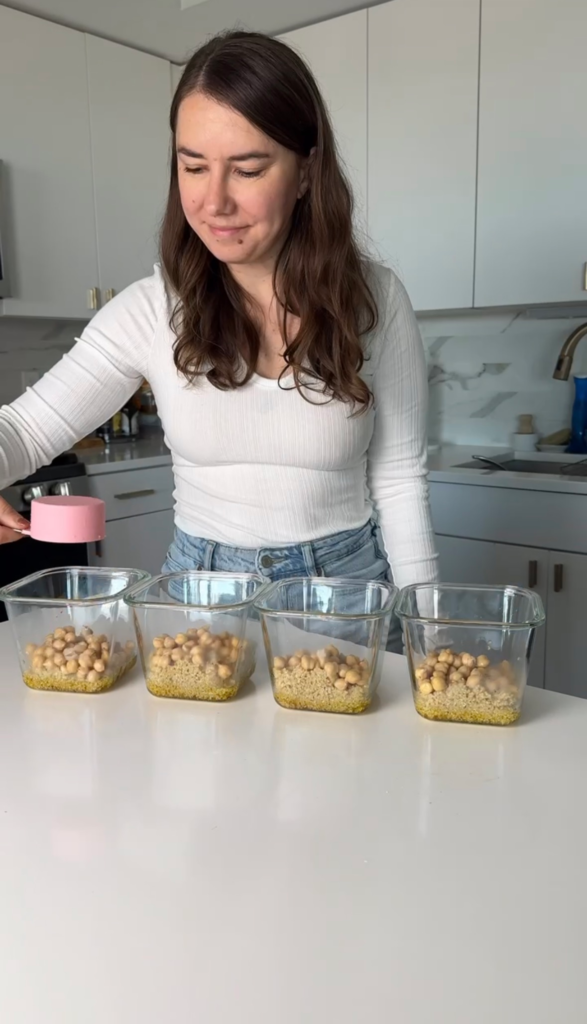 Quinoa and chickpeas layered into meal prep containers