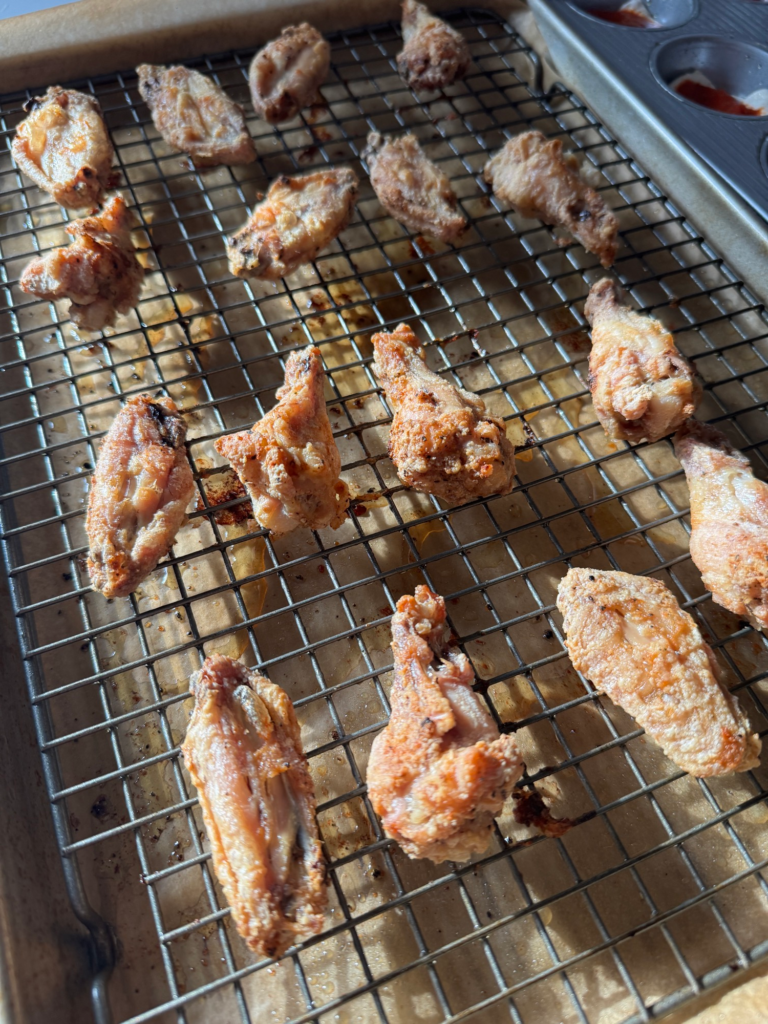 Crispy baked chicken wings on a wire rack