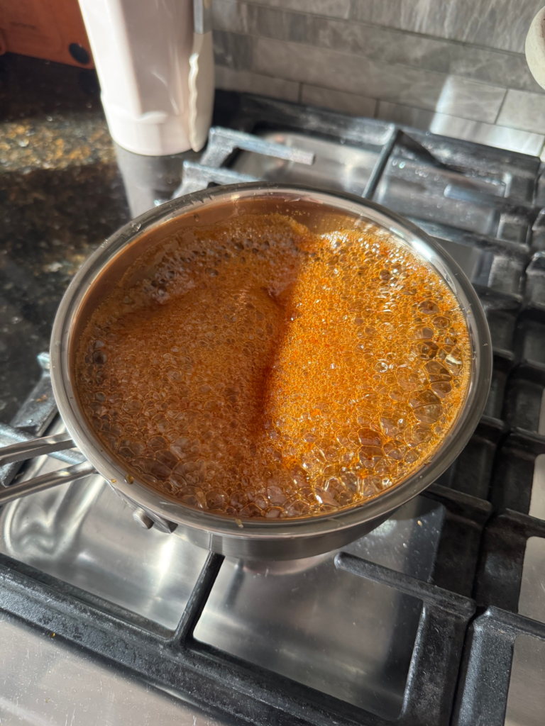 Honey garlic glaze simmering in a saucepan