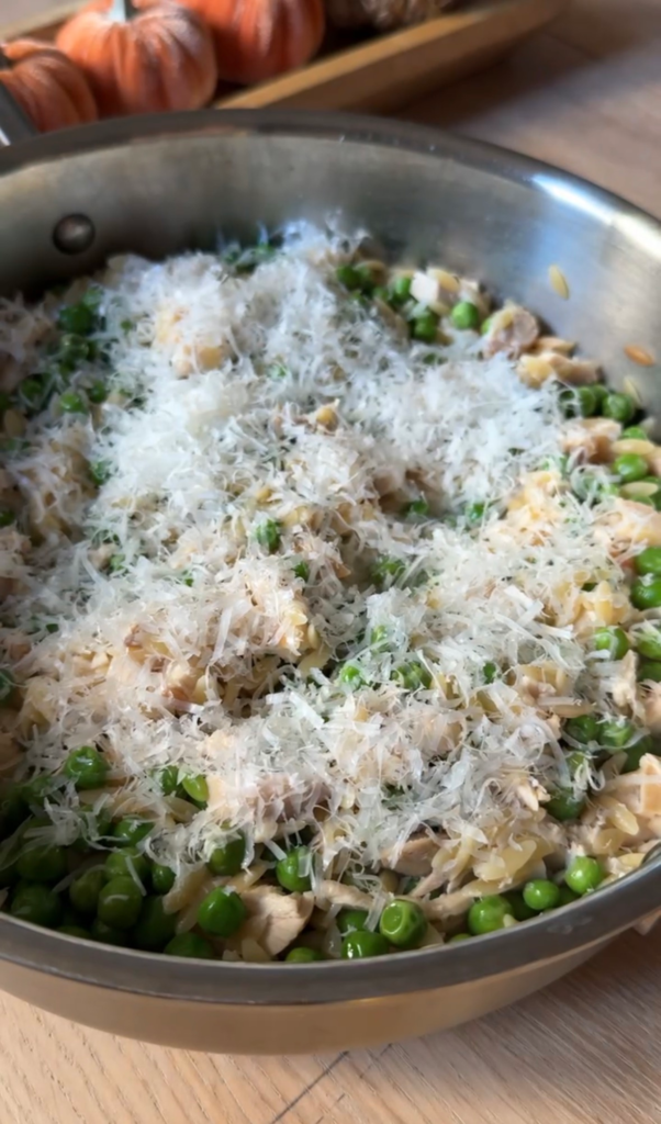 Freshly grated Parmesan over peas and parmesan orzo