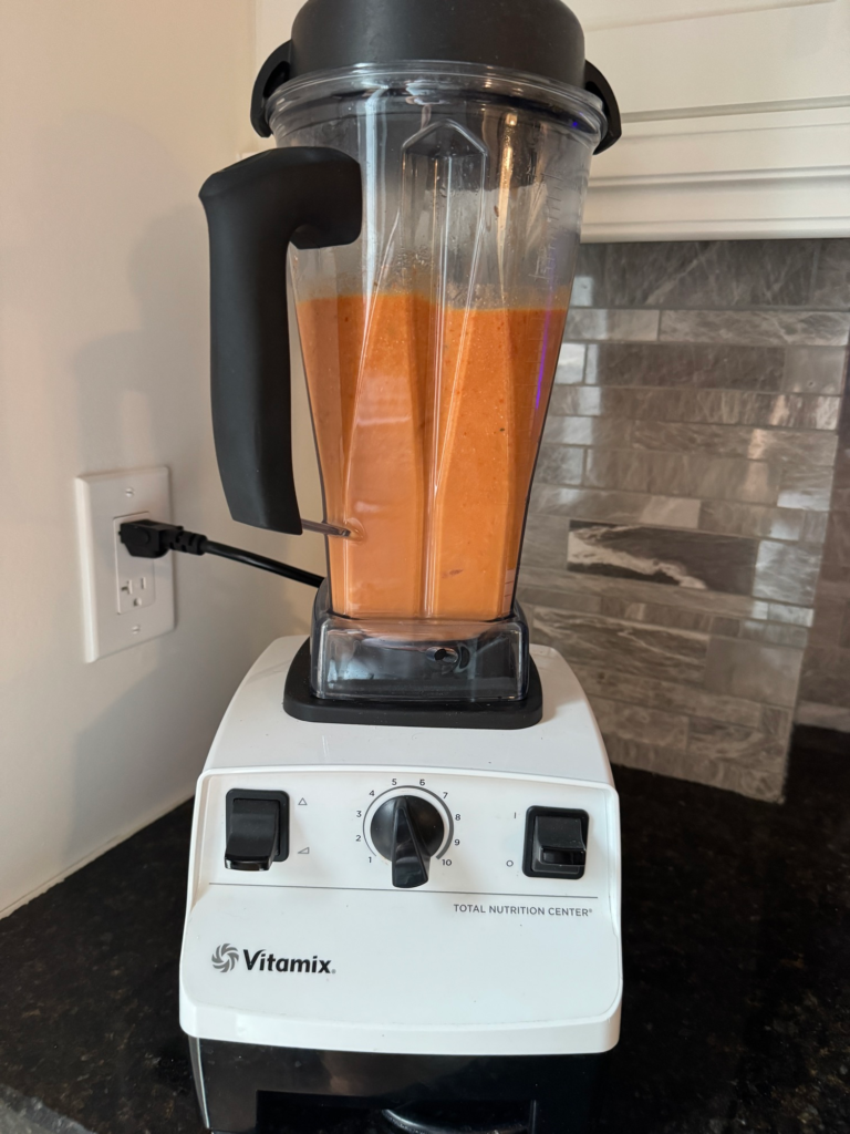 Creamy roasted tomato soup blending in a blender