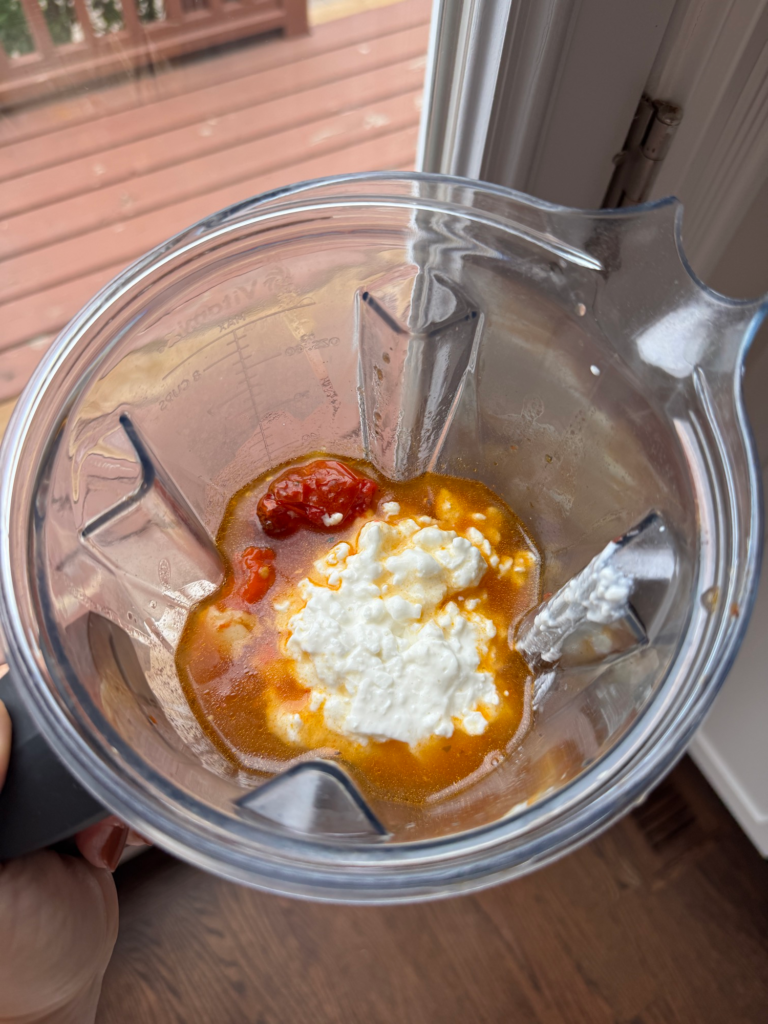 Roasted tomatoes, broth, and cottage cheese in a blender