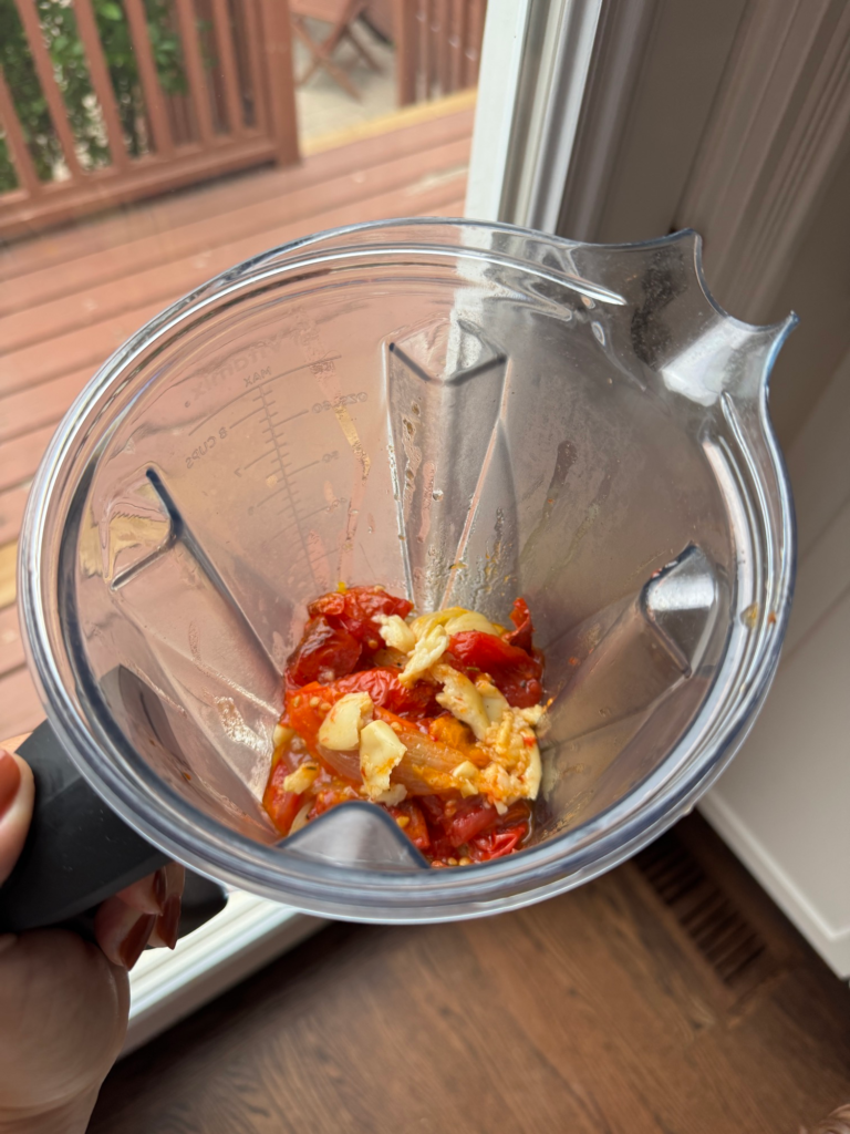 Roasted tomatoes and garlic in a blender