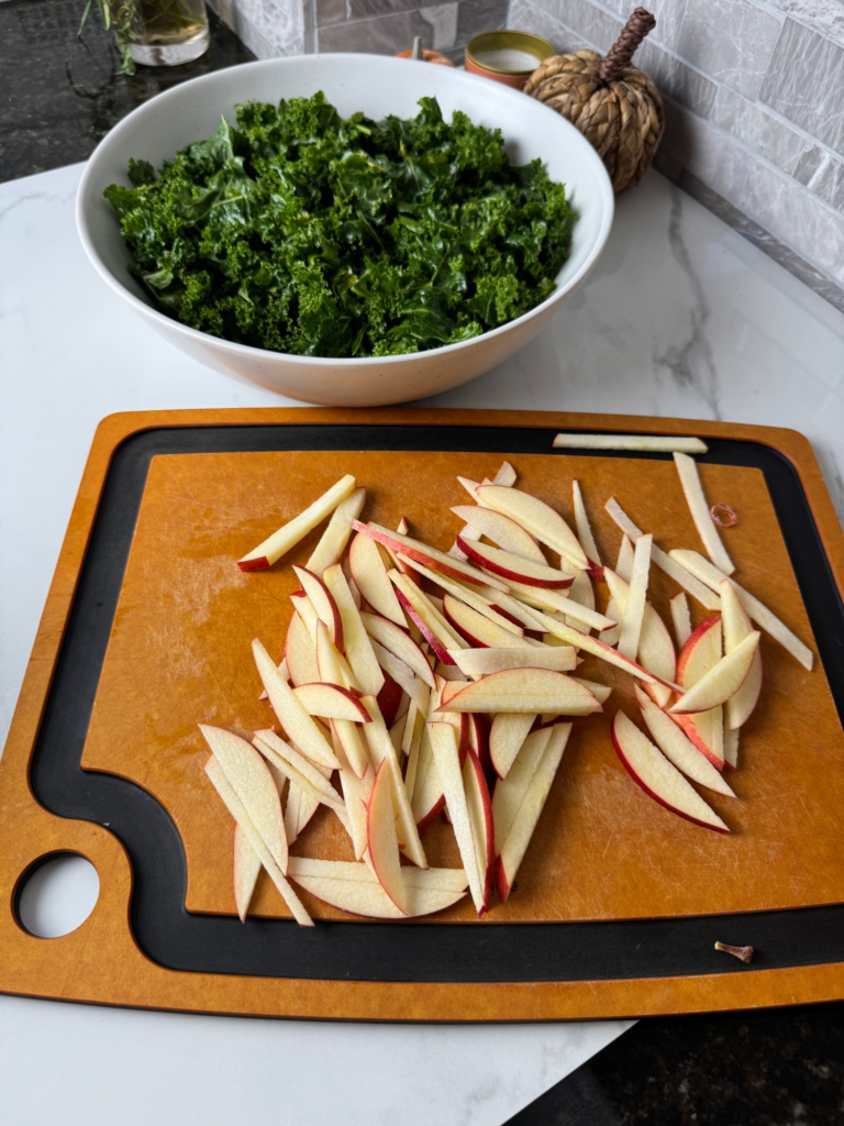 Apple cut into thin matchsticks next to a bowl of kale