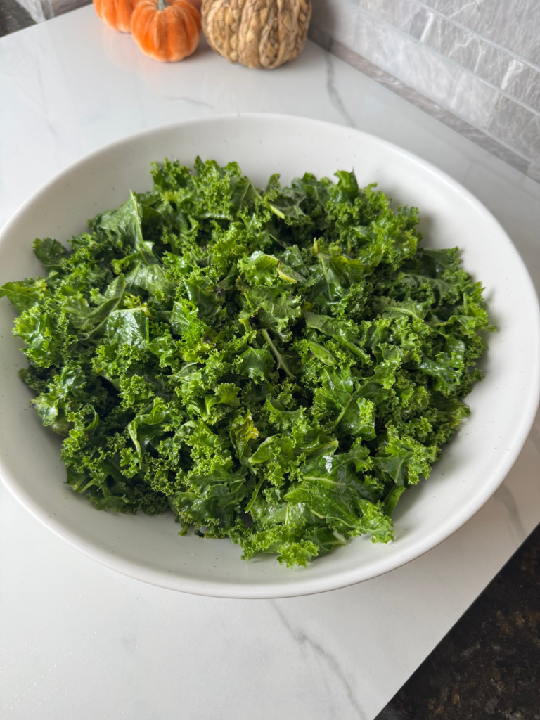Massaged kale in a white bowl