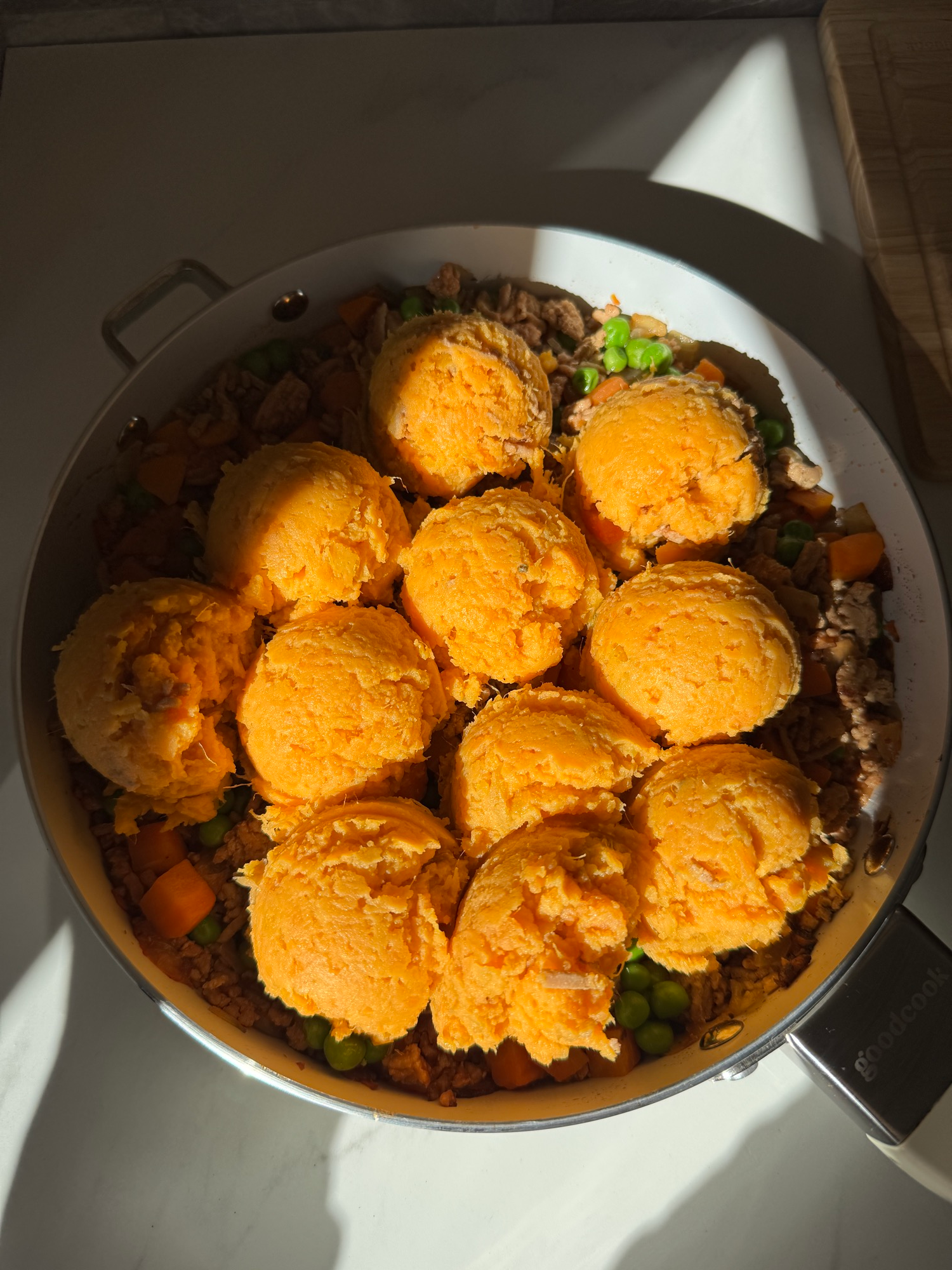 Scoops of mashed sweet potato layered over turkey and vegetable filling