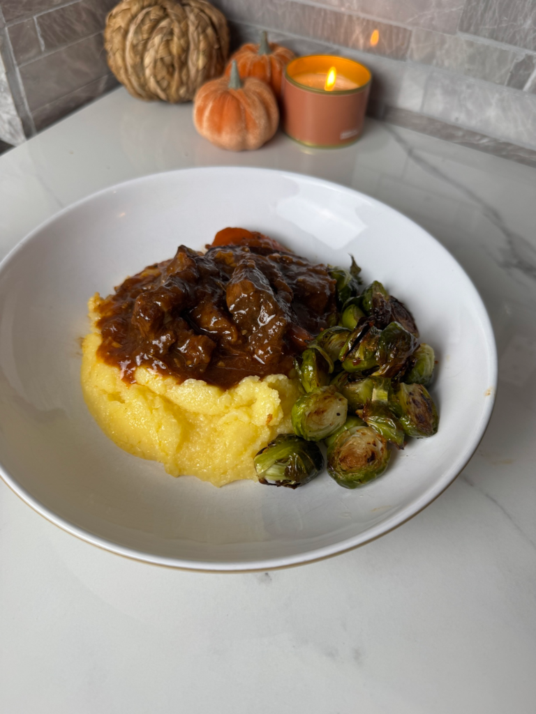 Braised beef ribs served over creamy polenta with brussels sprouts