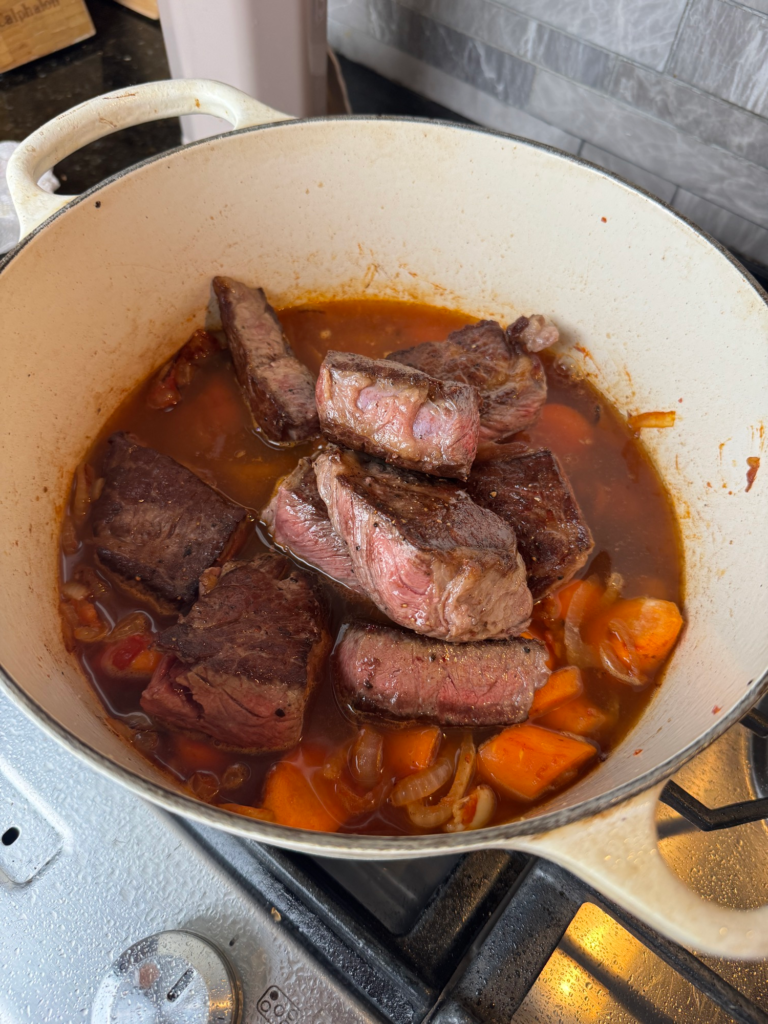 Seared beef ribs returned to the pot before braising