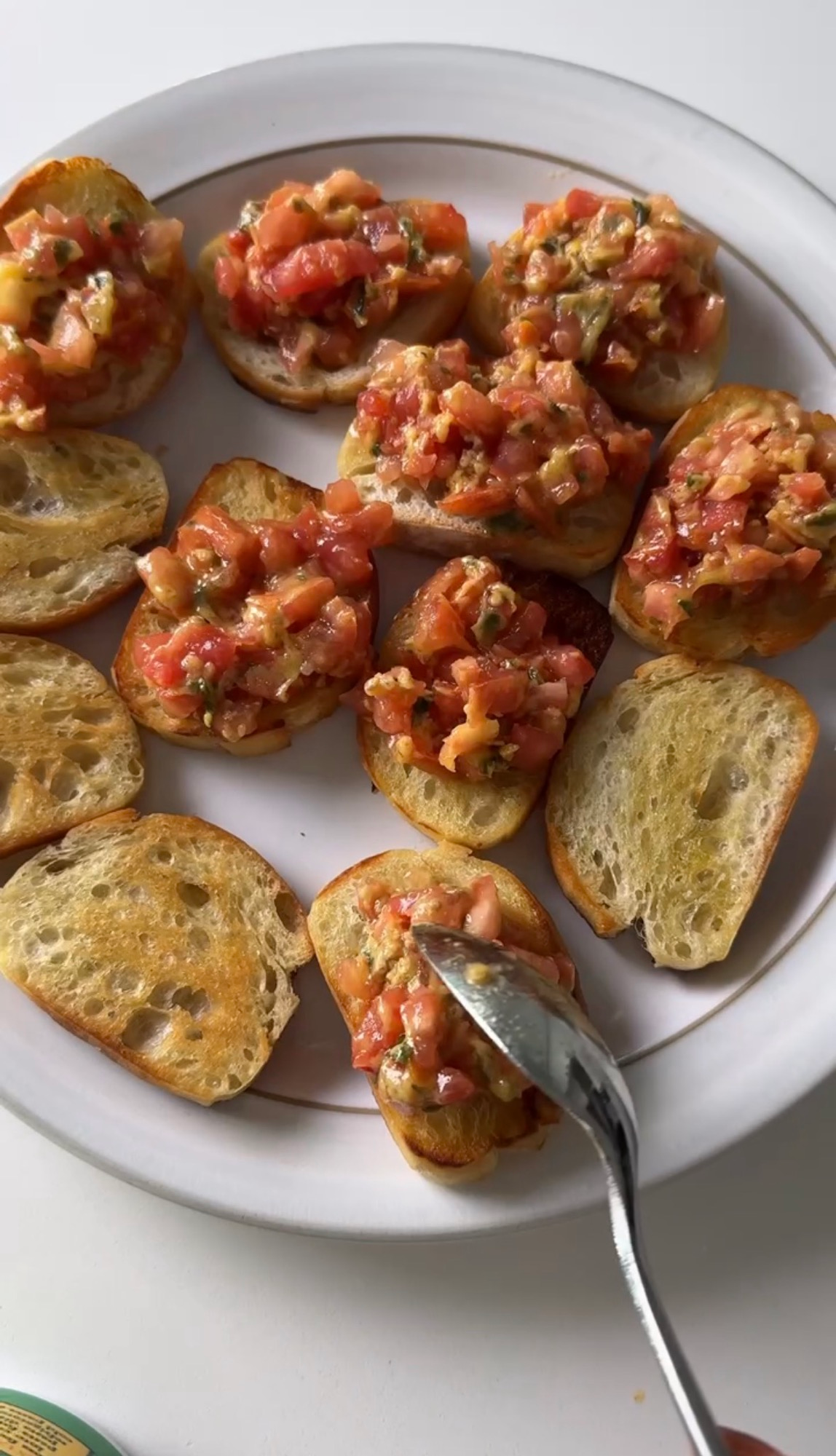 Crostini topped with bruschetta before adding the mozzarella ghosts