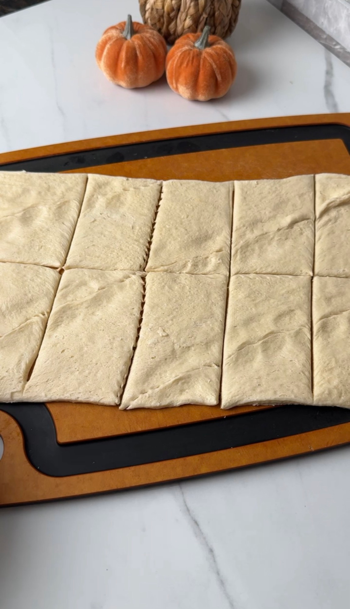 Crescent roll dough cut into squares for ghost dogs