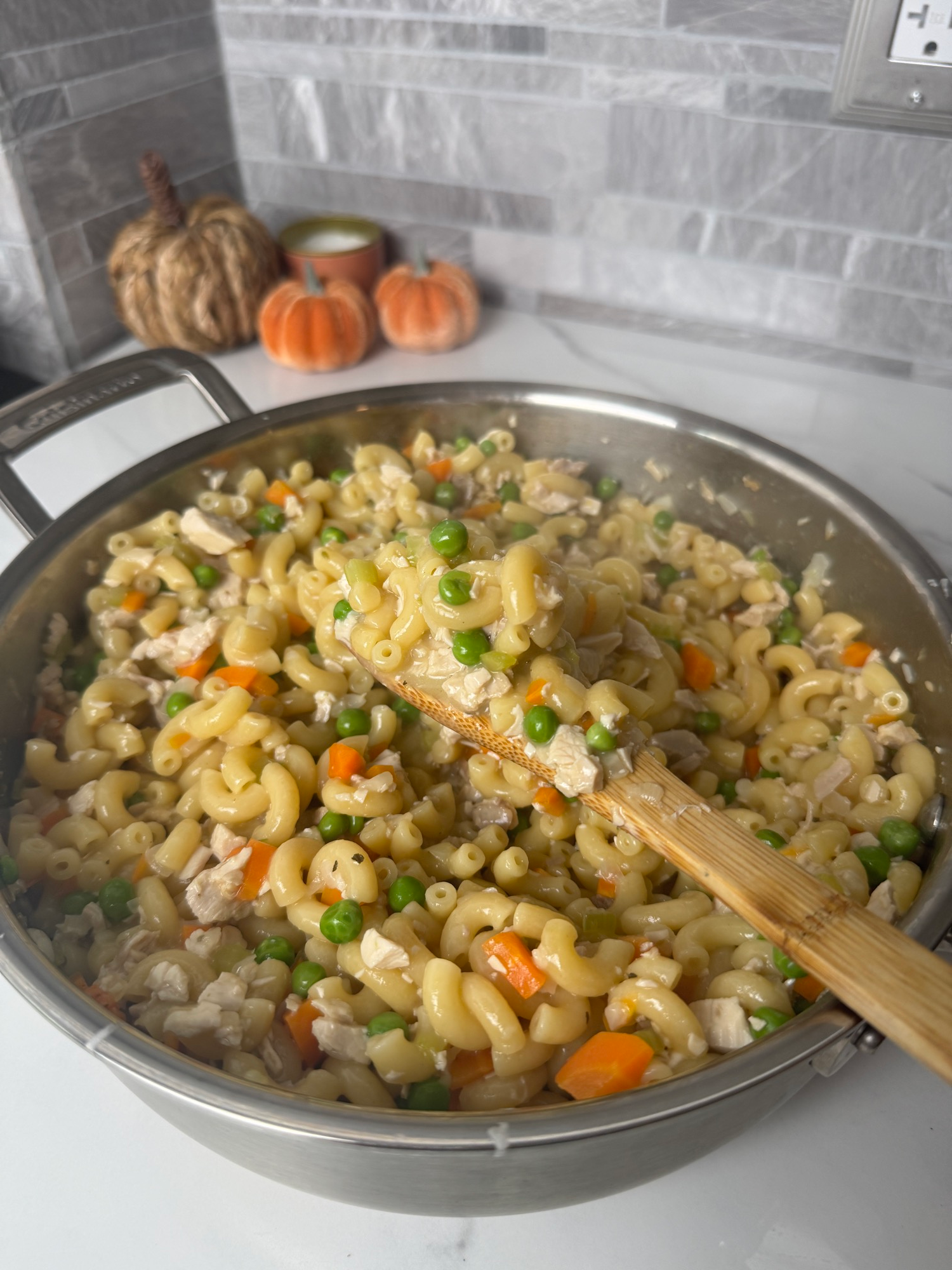 One-pot leftover turkey pot pie pasta with a wooden spoon