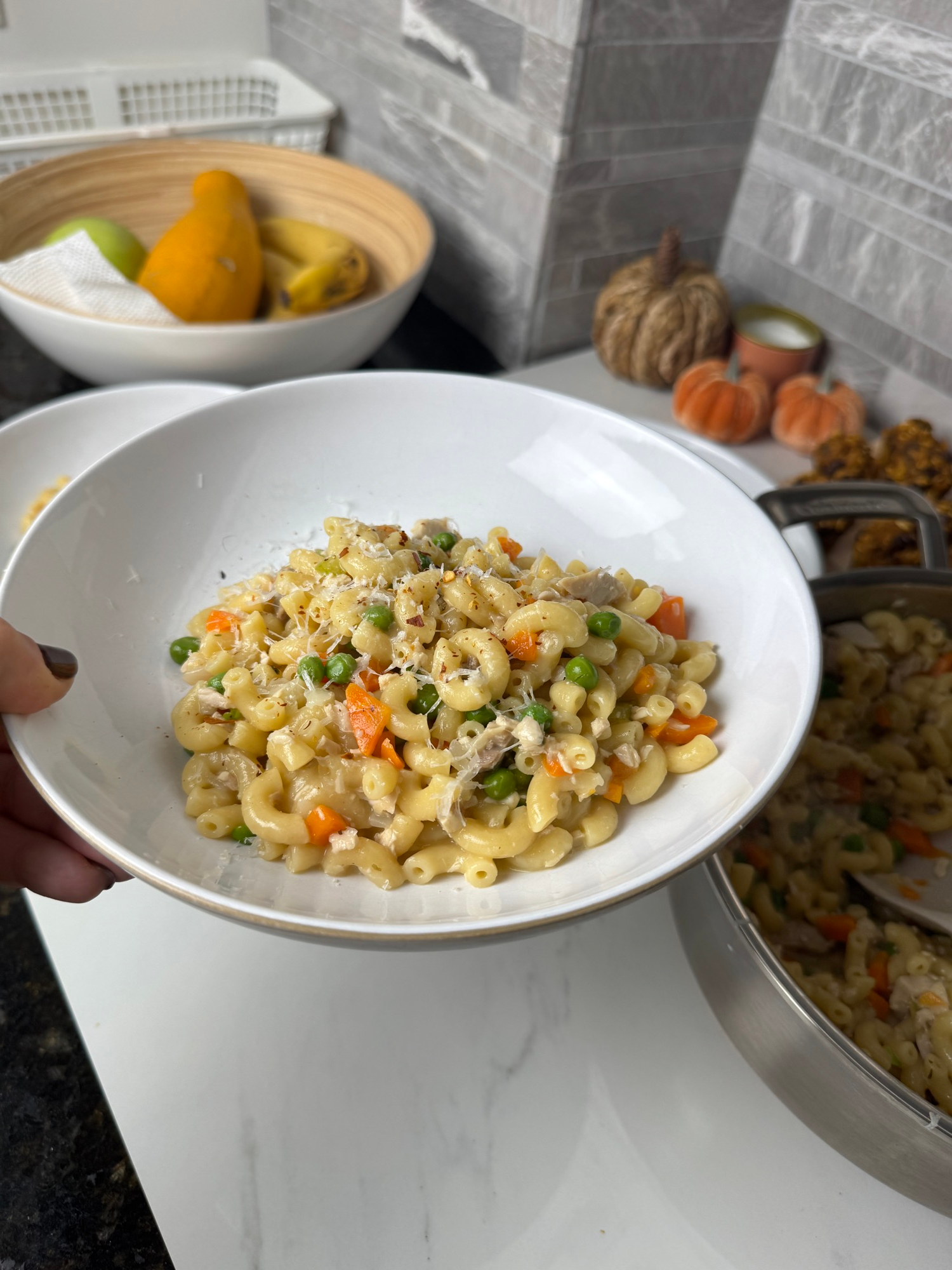 Leftover turkey pot pie pasta plated with peas, carrots, and parmesan