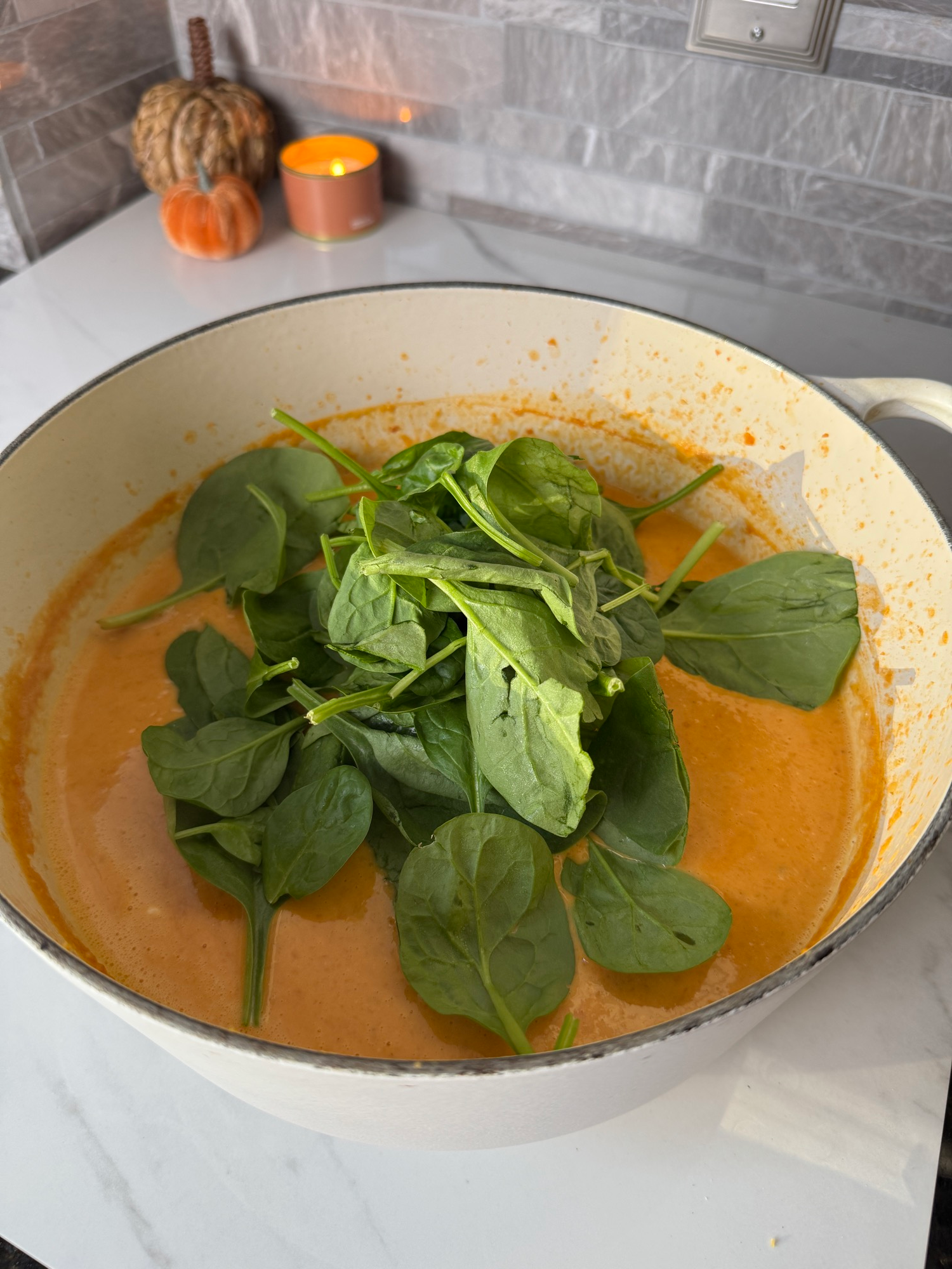 Whole spinach leaves added to creamy blended lentil soup