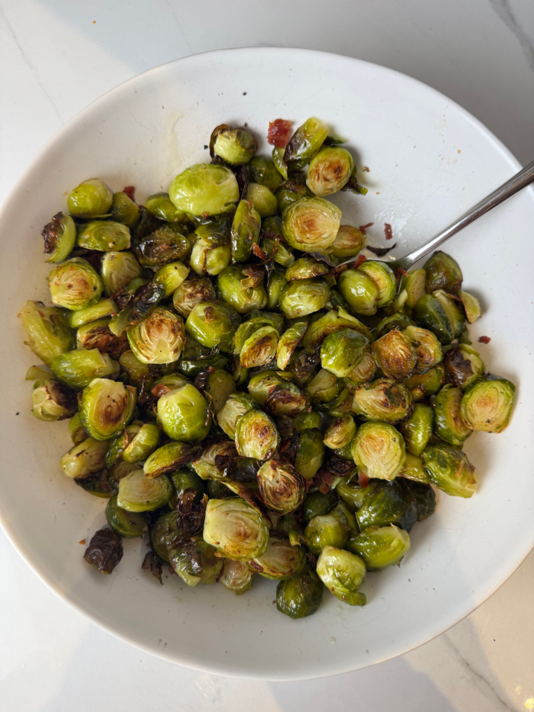 A bowl of maple bacon brussels sprouts with crispy bacon