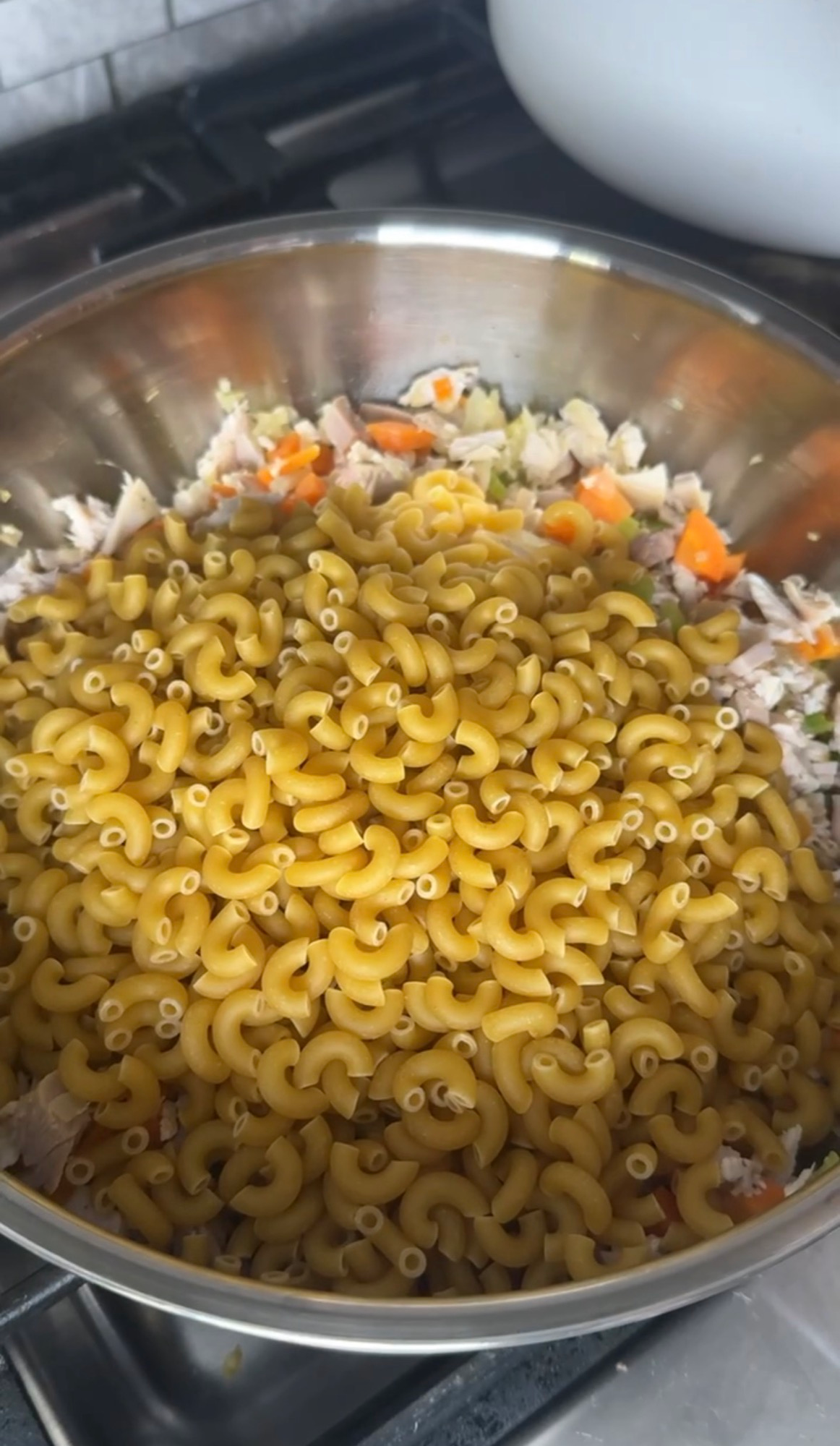 Dry macaroni added to the pot with turkey and vegetables