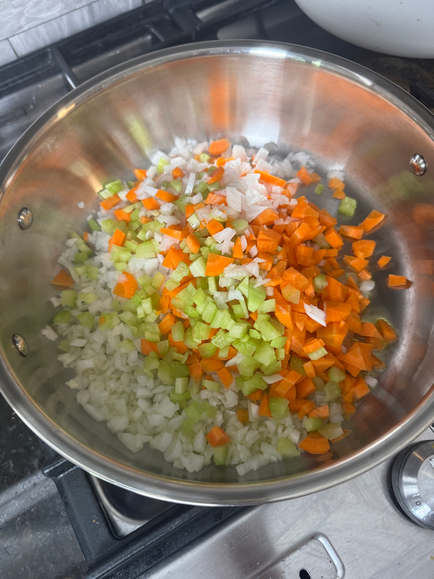 Diced onion, carrot, and celery sauteing in a pot