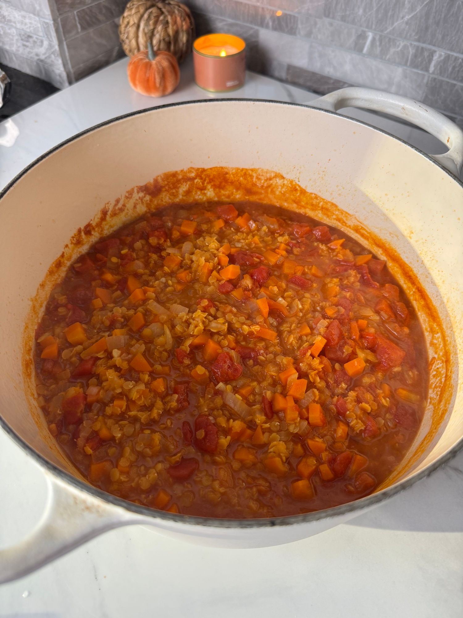 Cooked red lentil soup with carrots and tomatoes before blending