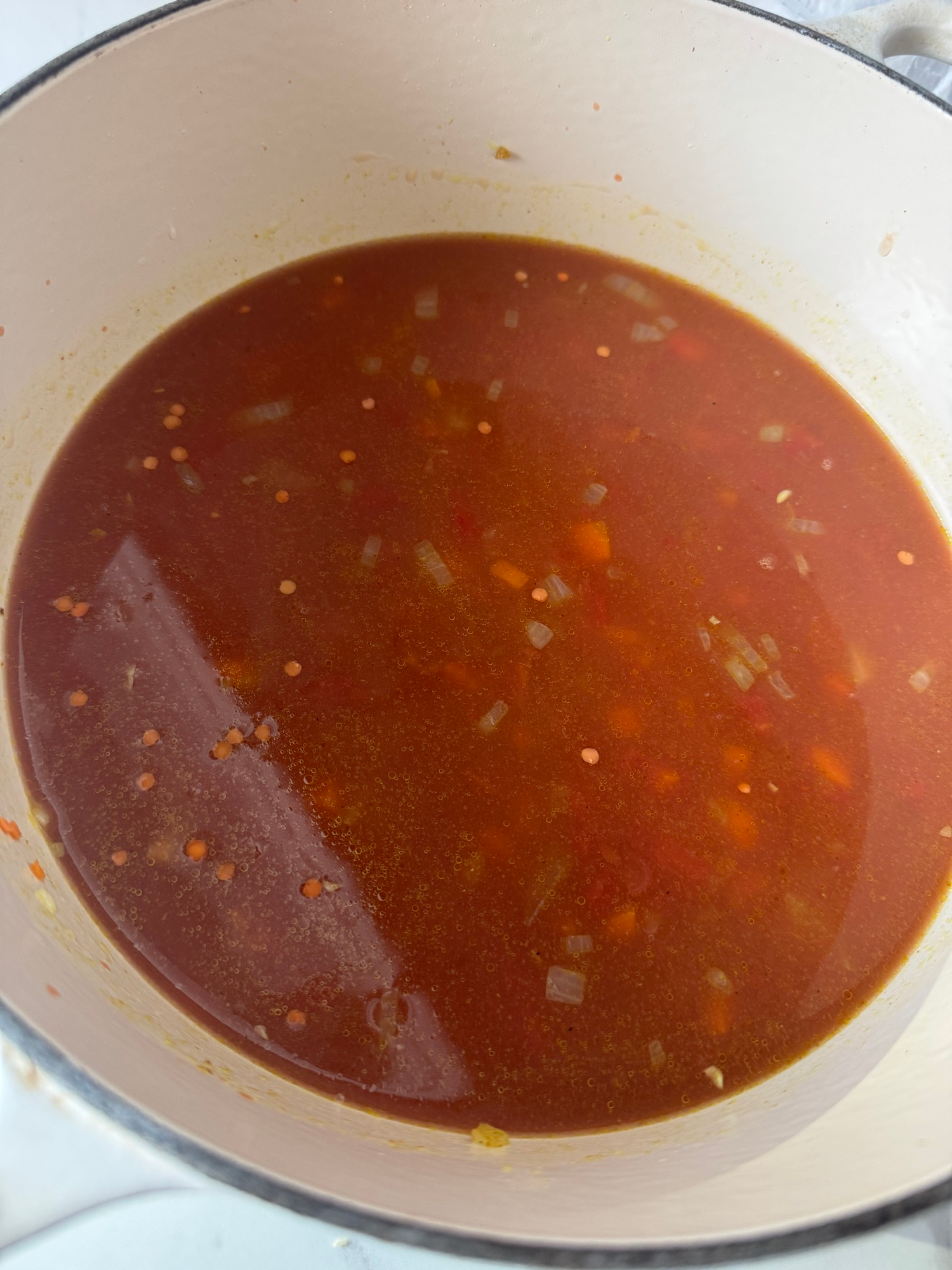 Spiced lentil soup simmering with lentils, tomatoes, and broth
