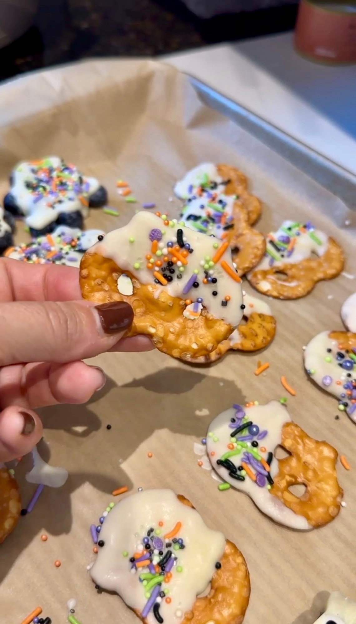 White chocolate covered pretzels with Halloween sprinkles